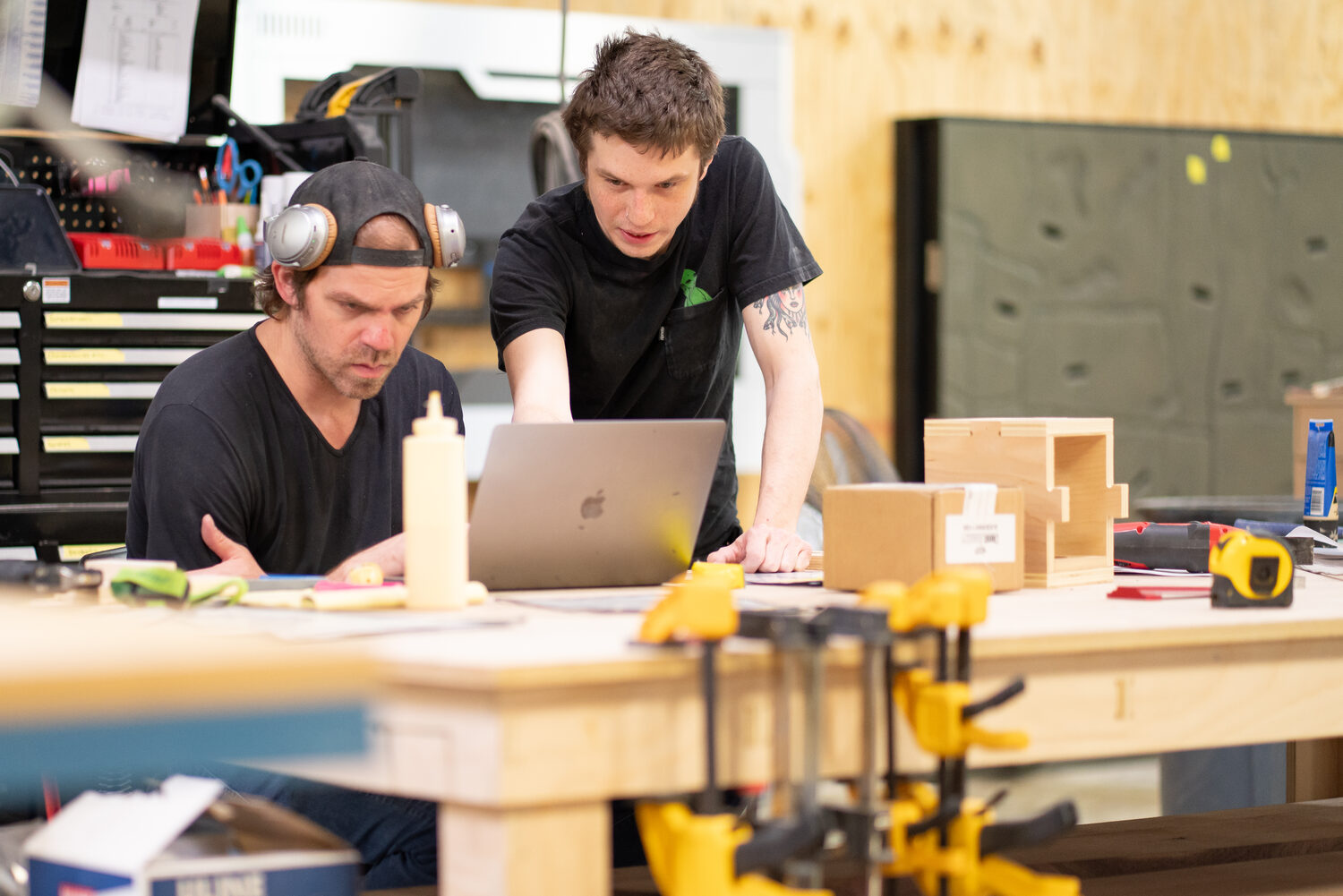 Team collaborating on a build at the bench