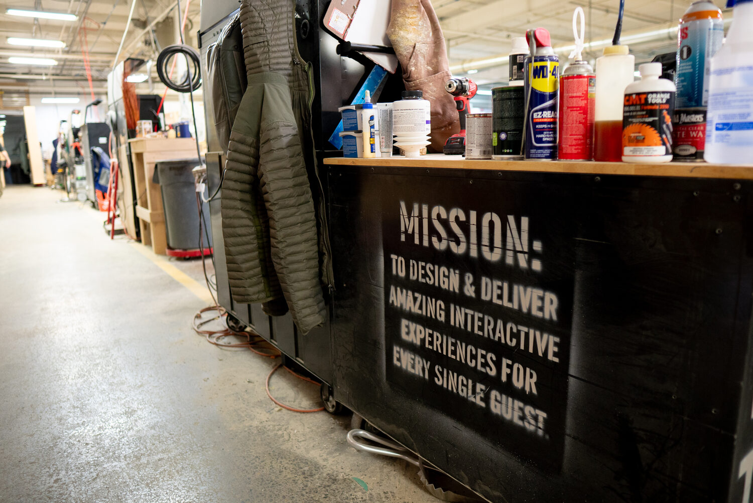 Mission statement painted on the shop wall: design and deliver EPIC interactive experiences